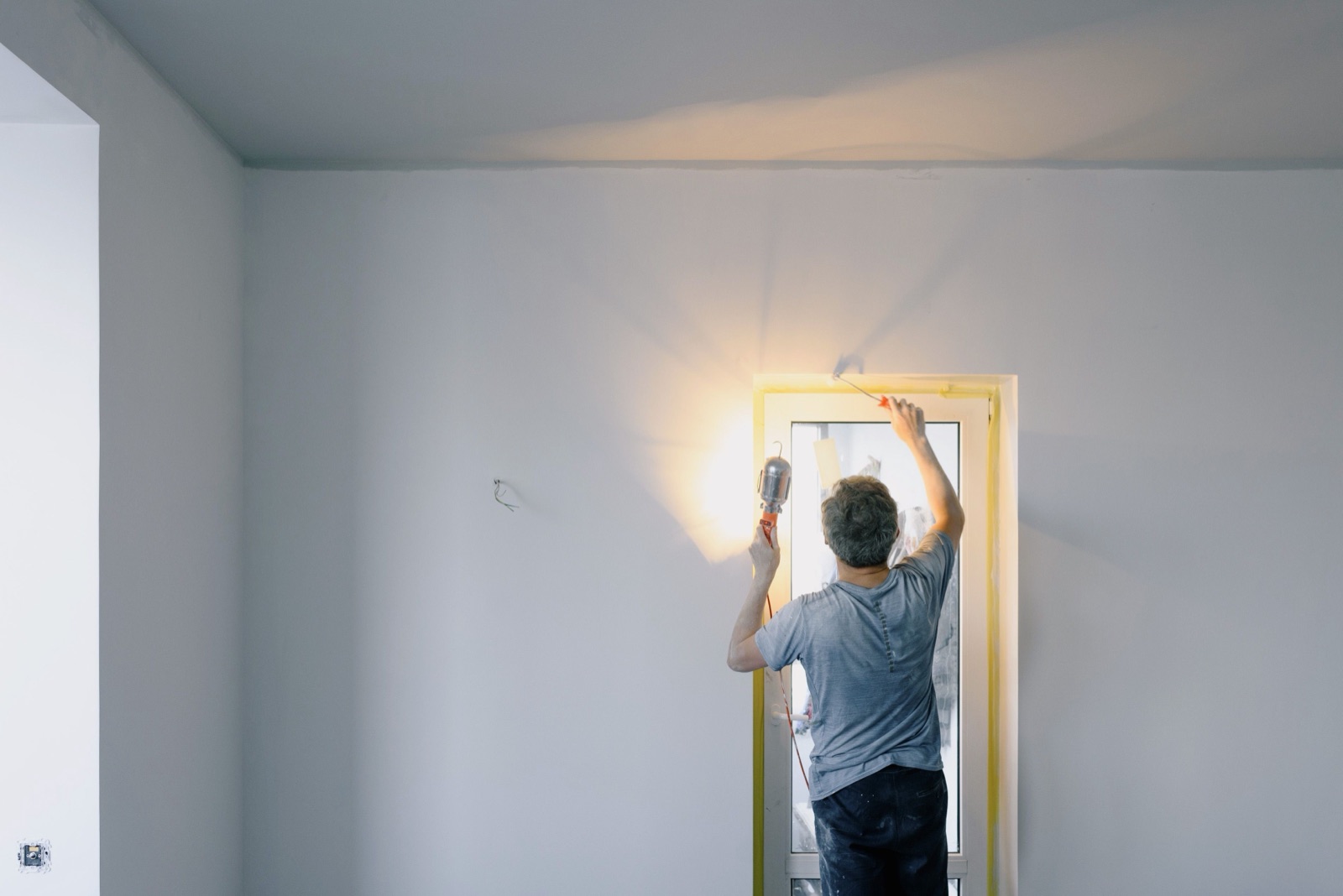 Finishing a door frame under a work light before the final walk